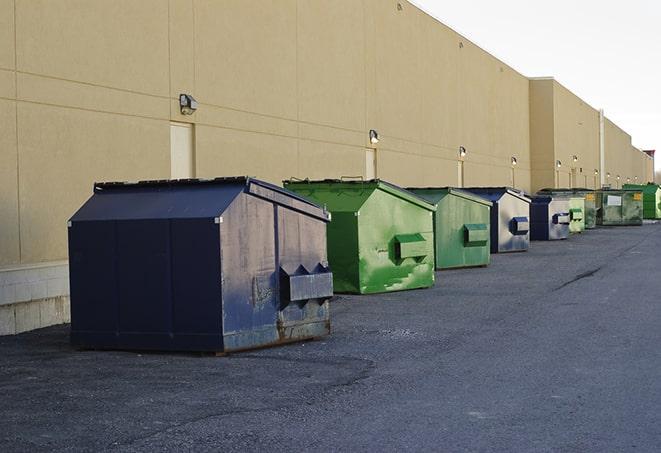 construction workers toss wood scraps into a dumpster in Crete, IL